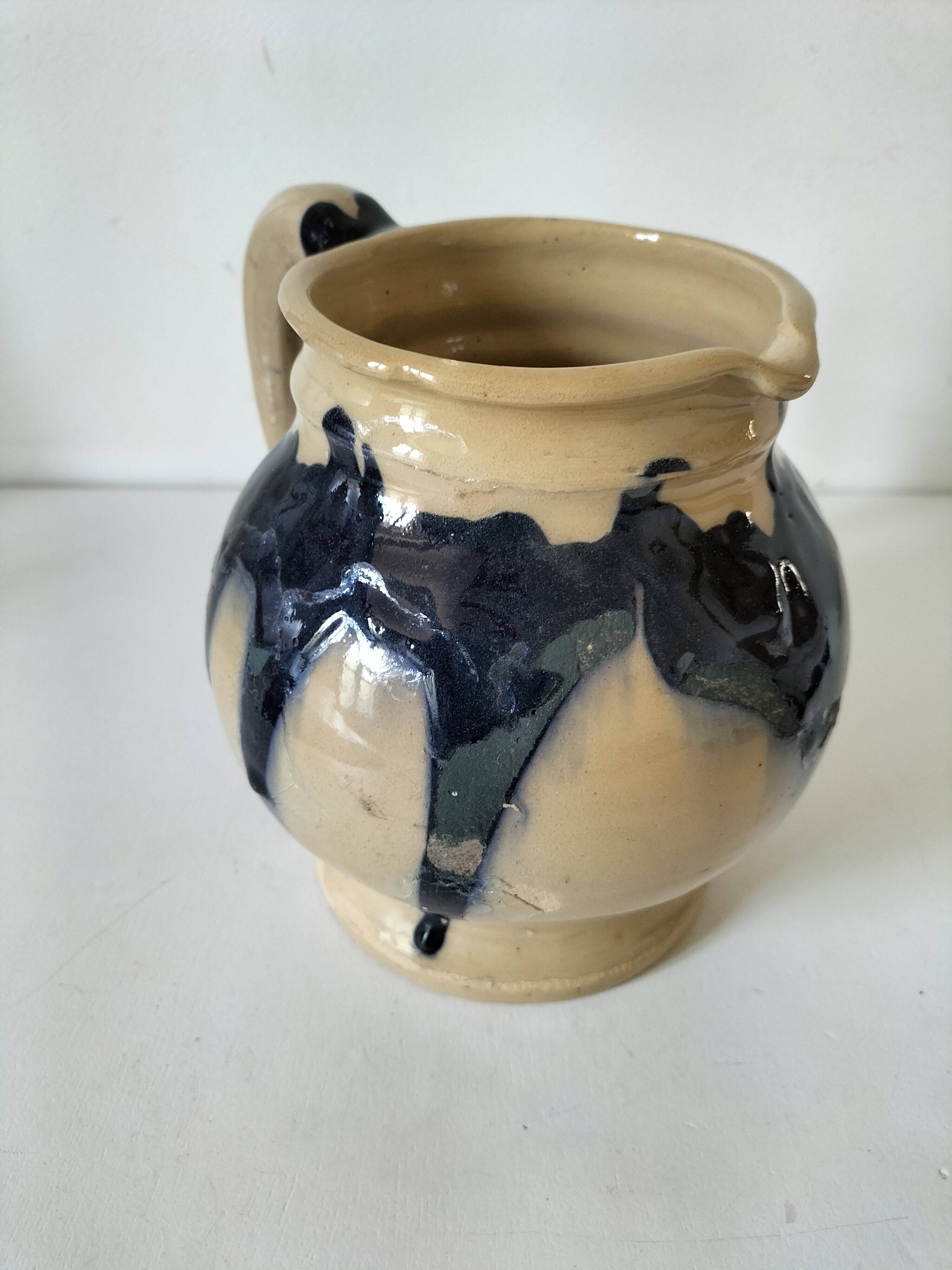 handcrafted ceramic jug with navy blue drip glaze.