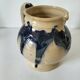 handcrafted ceramic jug with navy blue drip glaze.