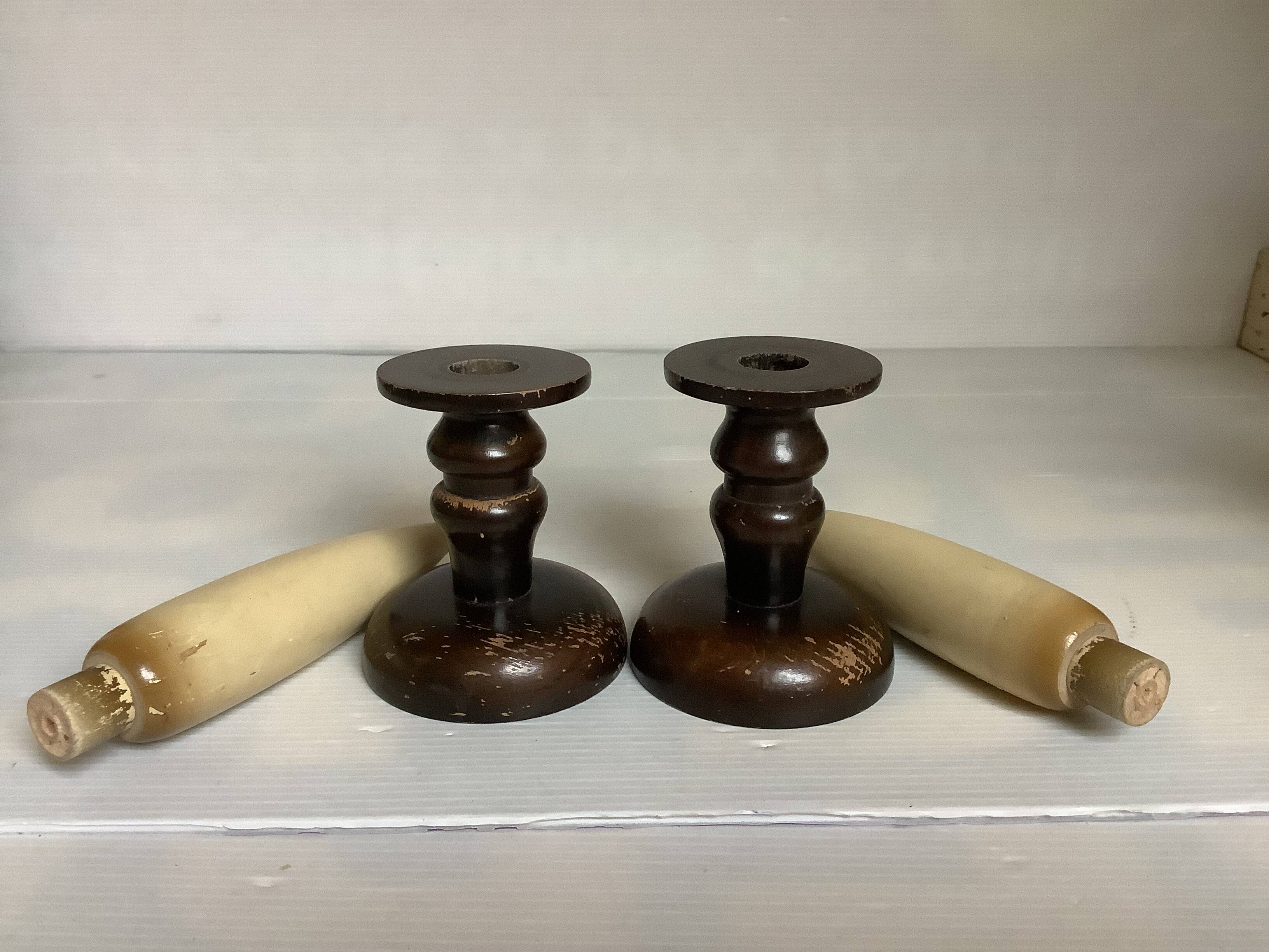 Pair of wooden candlesticks with fake wooden candles.