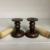 Pair of wooden candlesticks with fake wooden candles.