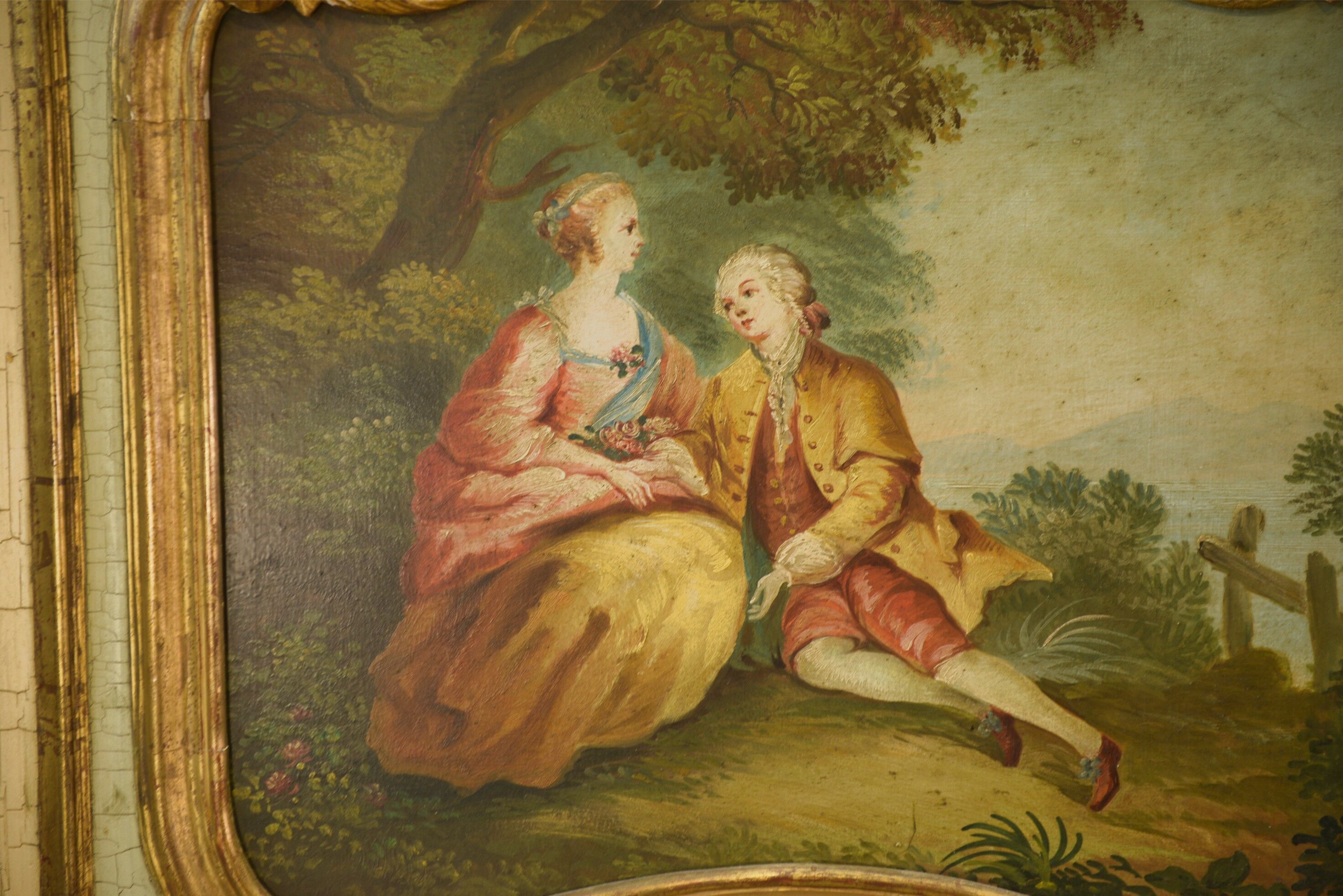 Trumeau mirror with cracked patina and oil on panel depicting a romantic scene from the 19th century.