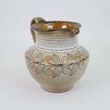 Glazed ceramic jug with plant decoration