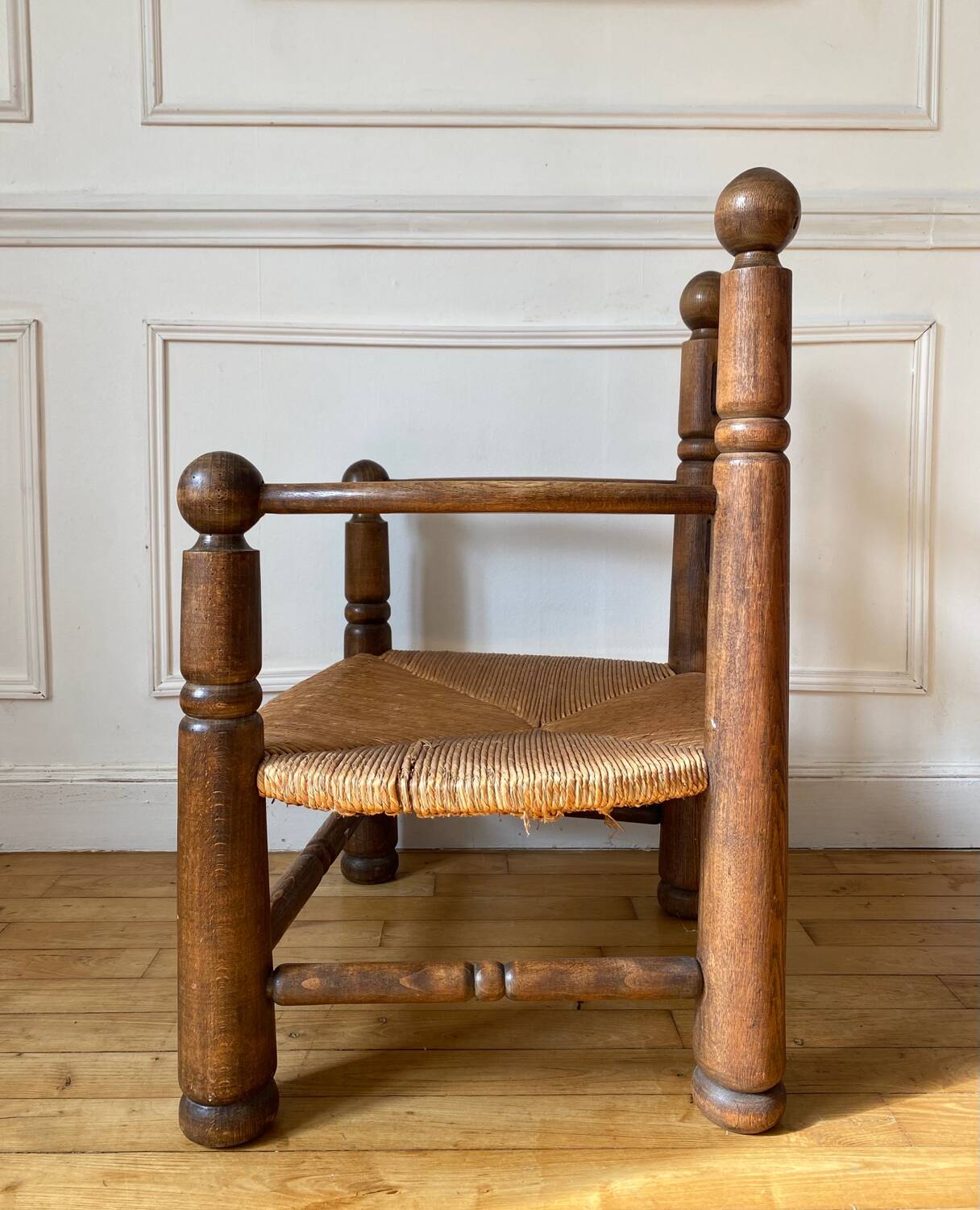 Straw and turned wood fireplace armchair in the style of Charles Dudouyt