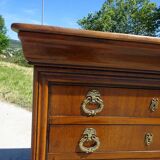Chest of drawers with decorated handles in the Louis XVI style.
