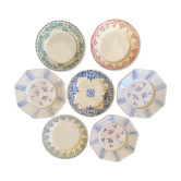 7 matching dessert plates in red green and blue.