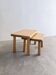 Two stools or small nesting tables in light oak.