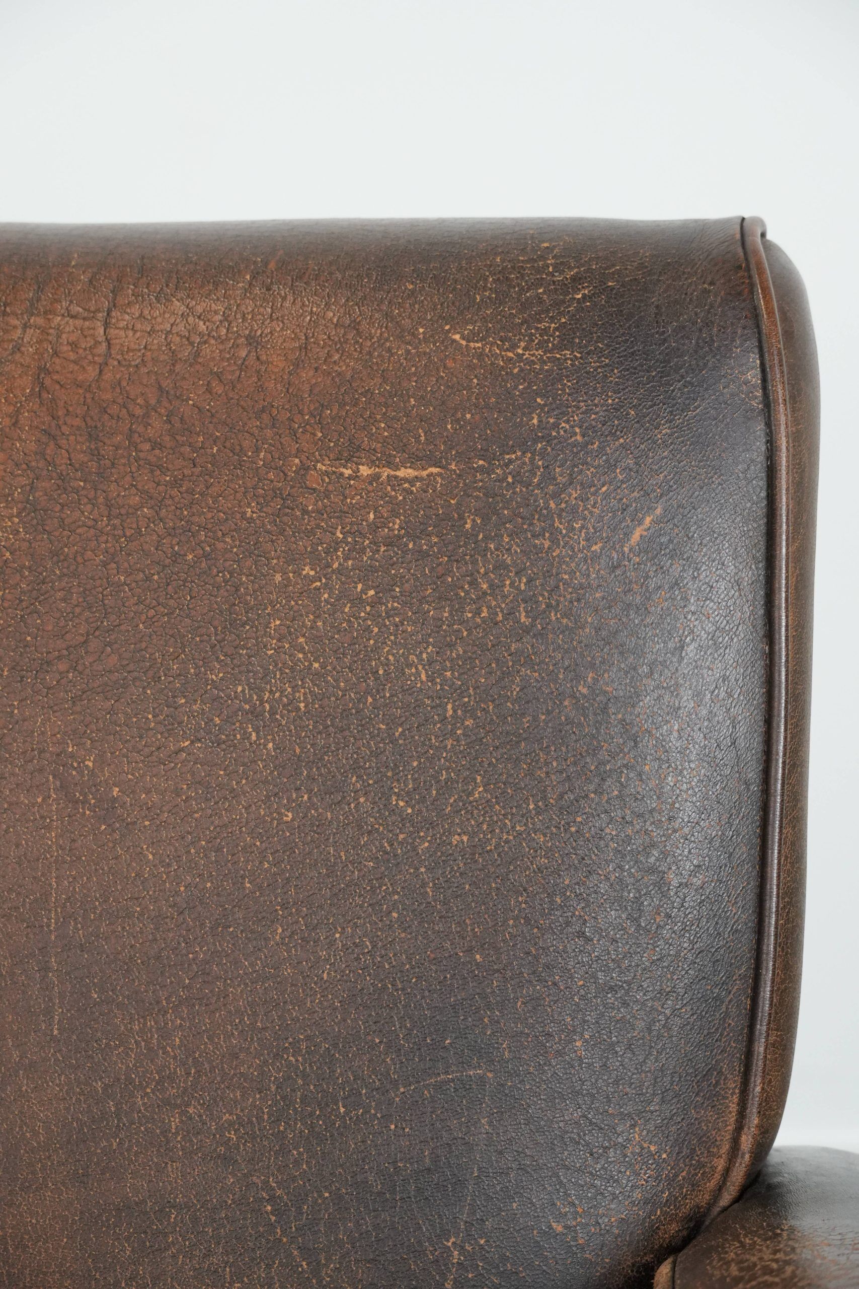 Set of two vintage sheepskin leather design armchairs in a cognac colour