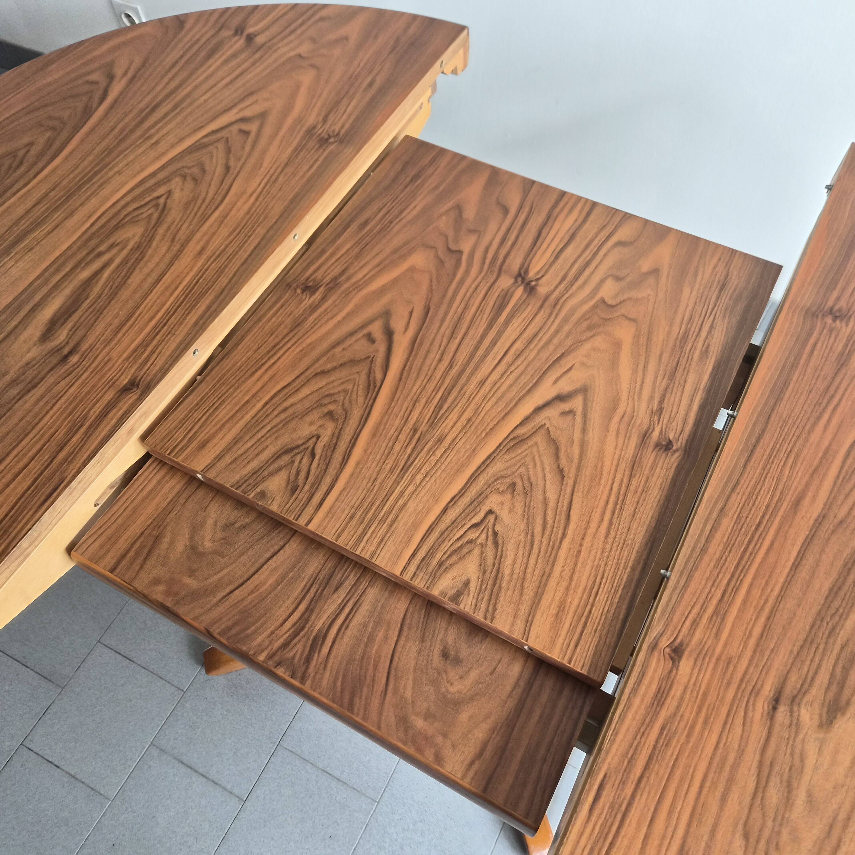 Baumann dining table 1960 extendable from 114 to 167 cm with integrated extensions.