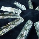 Set of 12 lead crystal knife rests in a triangular shape.