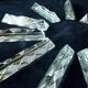 Set of 12 lead crystal knife rests in a triangular shape.