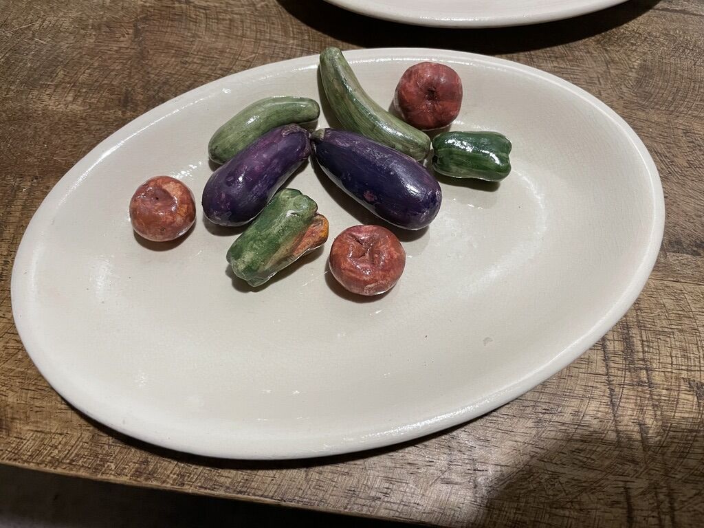 3 plates decorated with vegetables