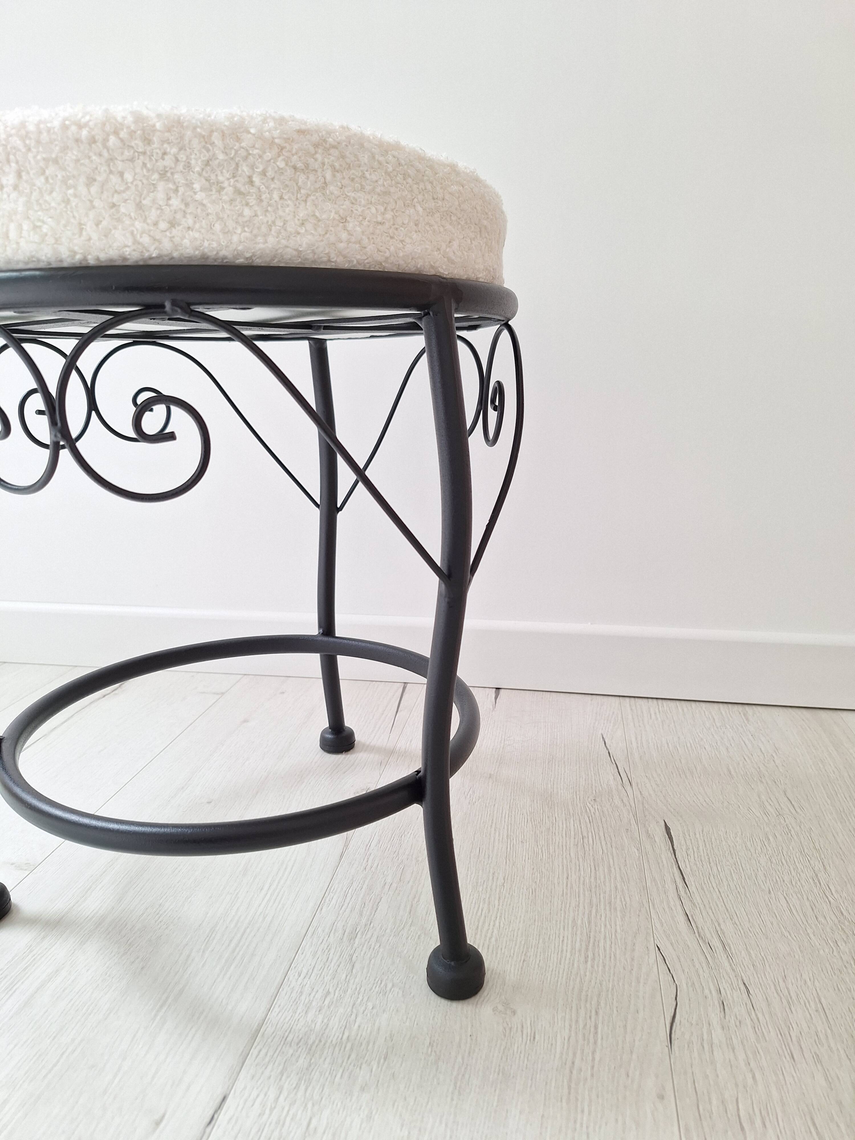 Black iron stool/pouf with its boucle fabric cushion.