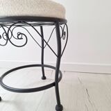Black iron stool/pouf with its boucle fabric cushion.