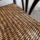 Set of two colonial dark-brown wooden armchairs with natural rattan seating (pair)