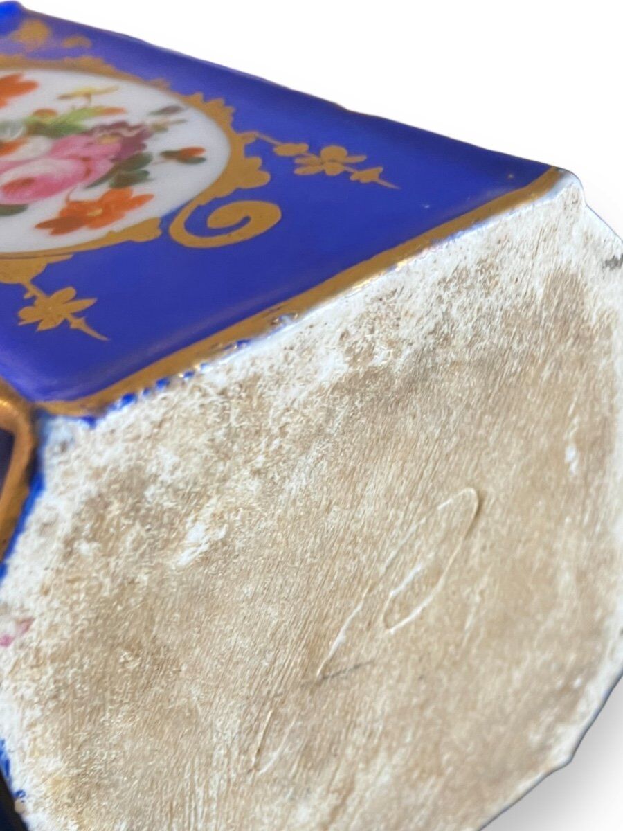 Perfume bottle in porcelain of old paris blue background