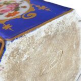 Perfume bottle in porcelain of old paris blue background