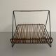 Mid-century black metal and rattan magazine rack, 1960, Italy