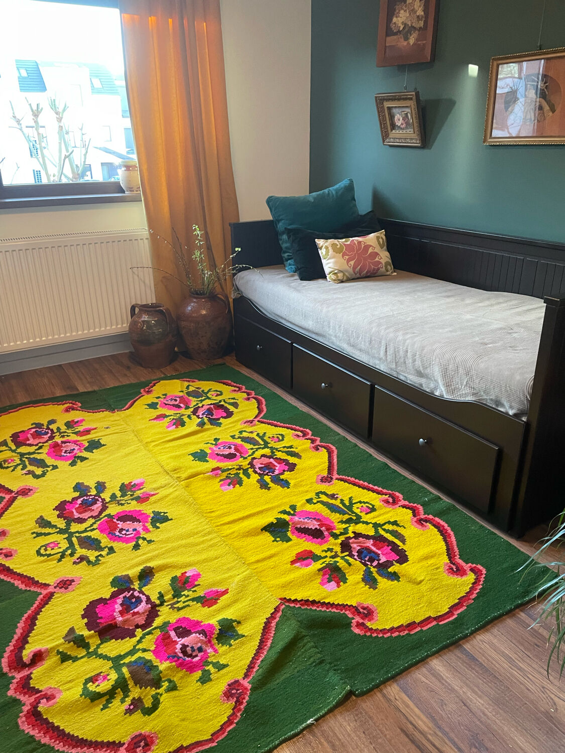 Vintage wool rug with pink flowers on green and yellow background made by hand in Transylvania