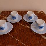 Set of four coffee cups with plates
