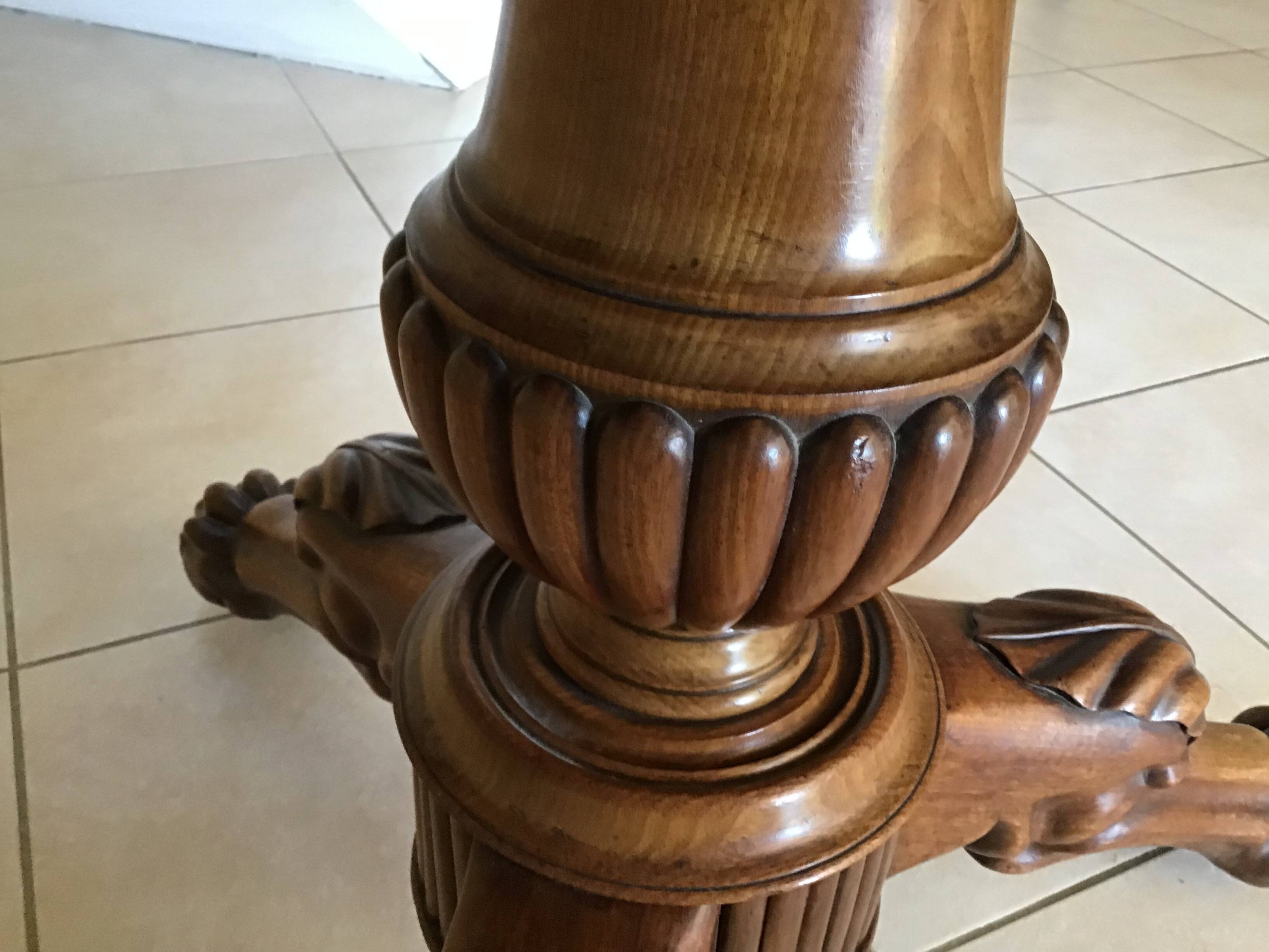 Wooden gueridon with marble, lion paw legs.