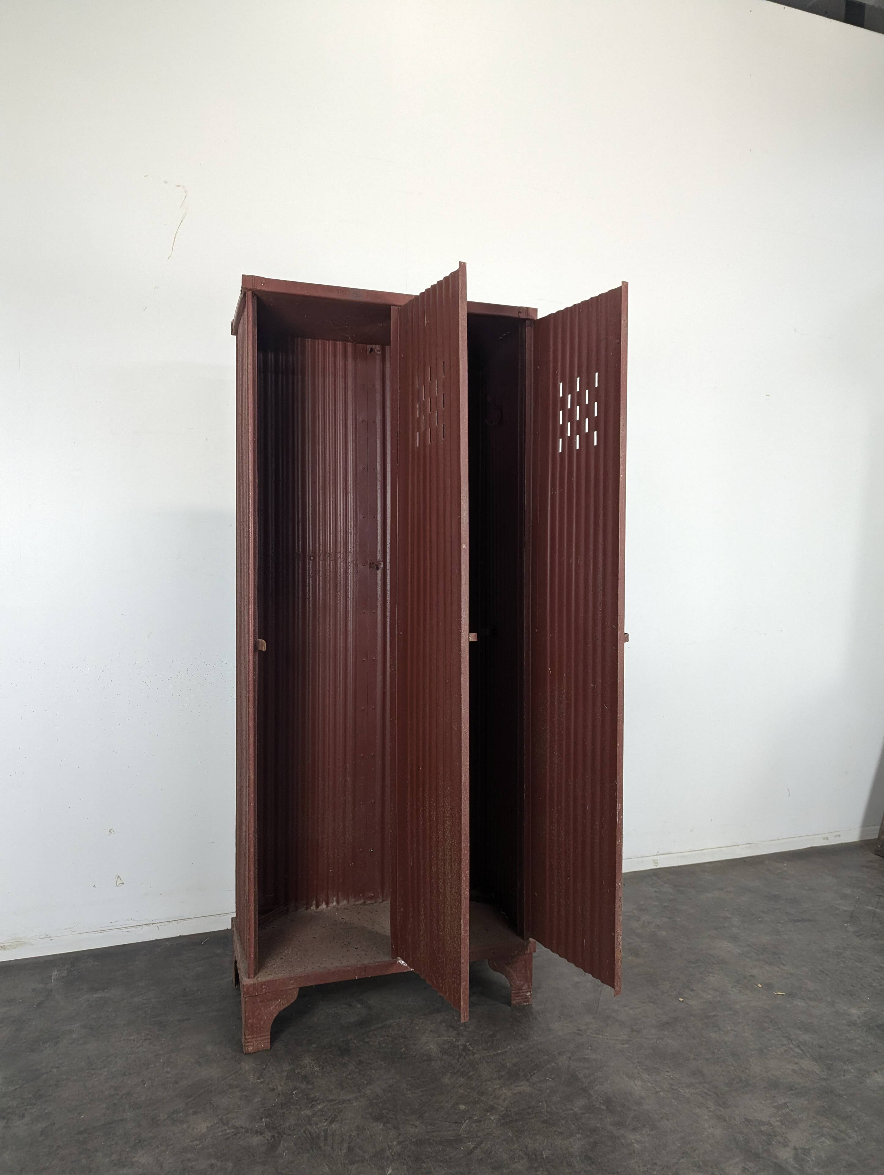 Red painted metal workshop locker with two doors.