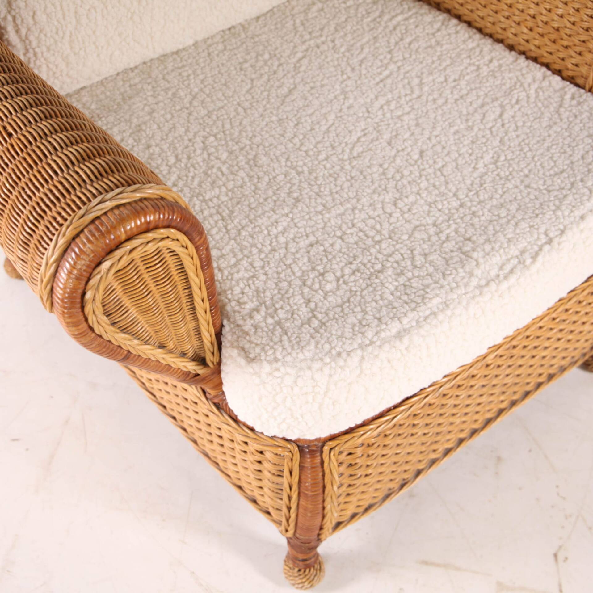 Large wicker armchair and its ottoman