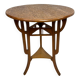 Round Art Nouveau coffee table with a sculpted top.