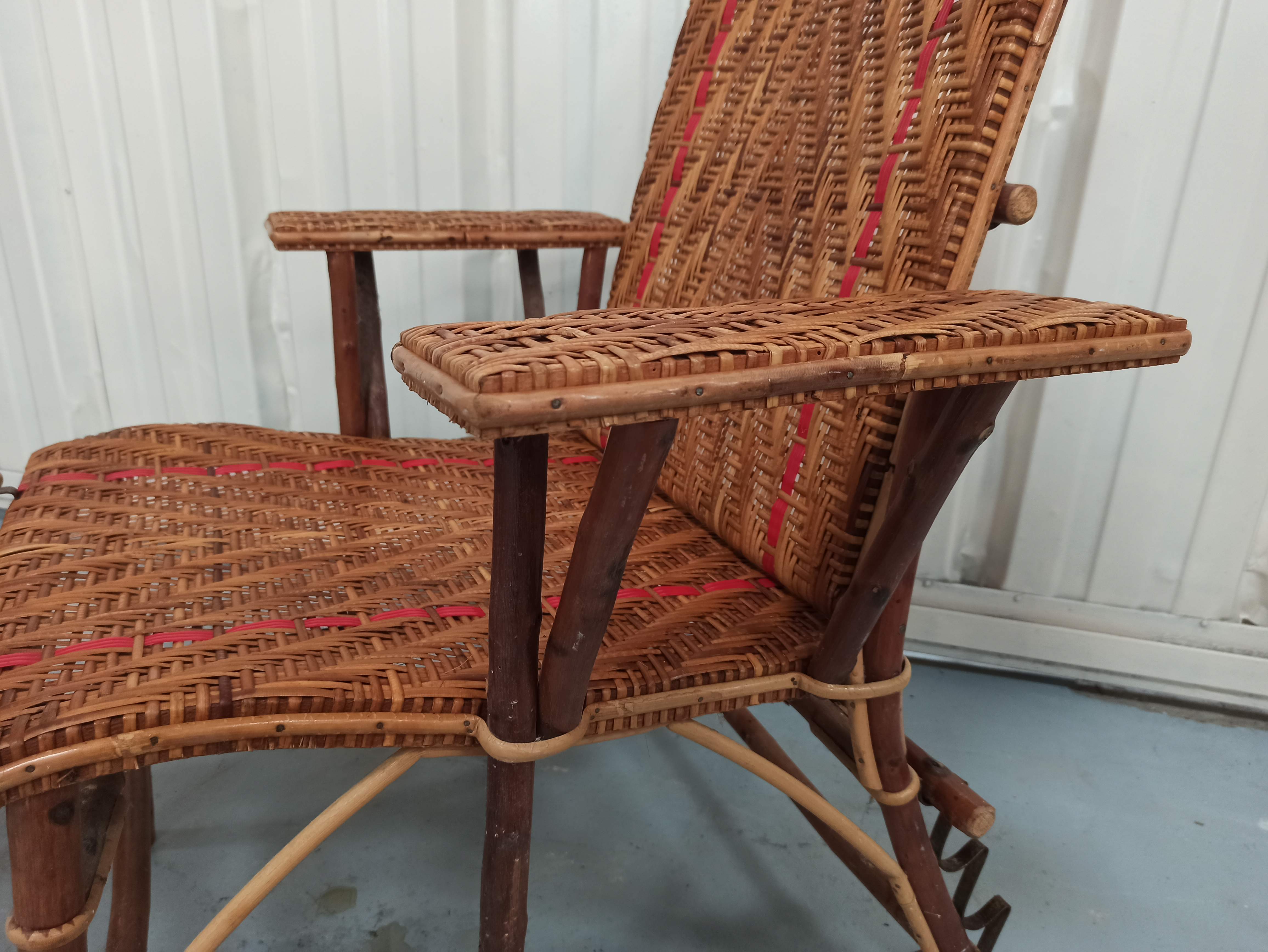 Sunbathing sunbathing in wicker rattan wood deckchair red lounger