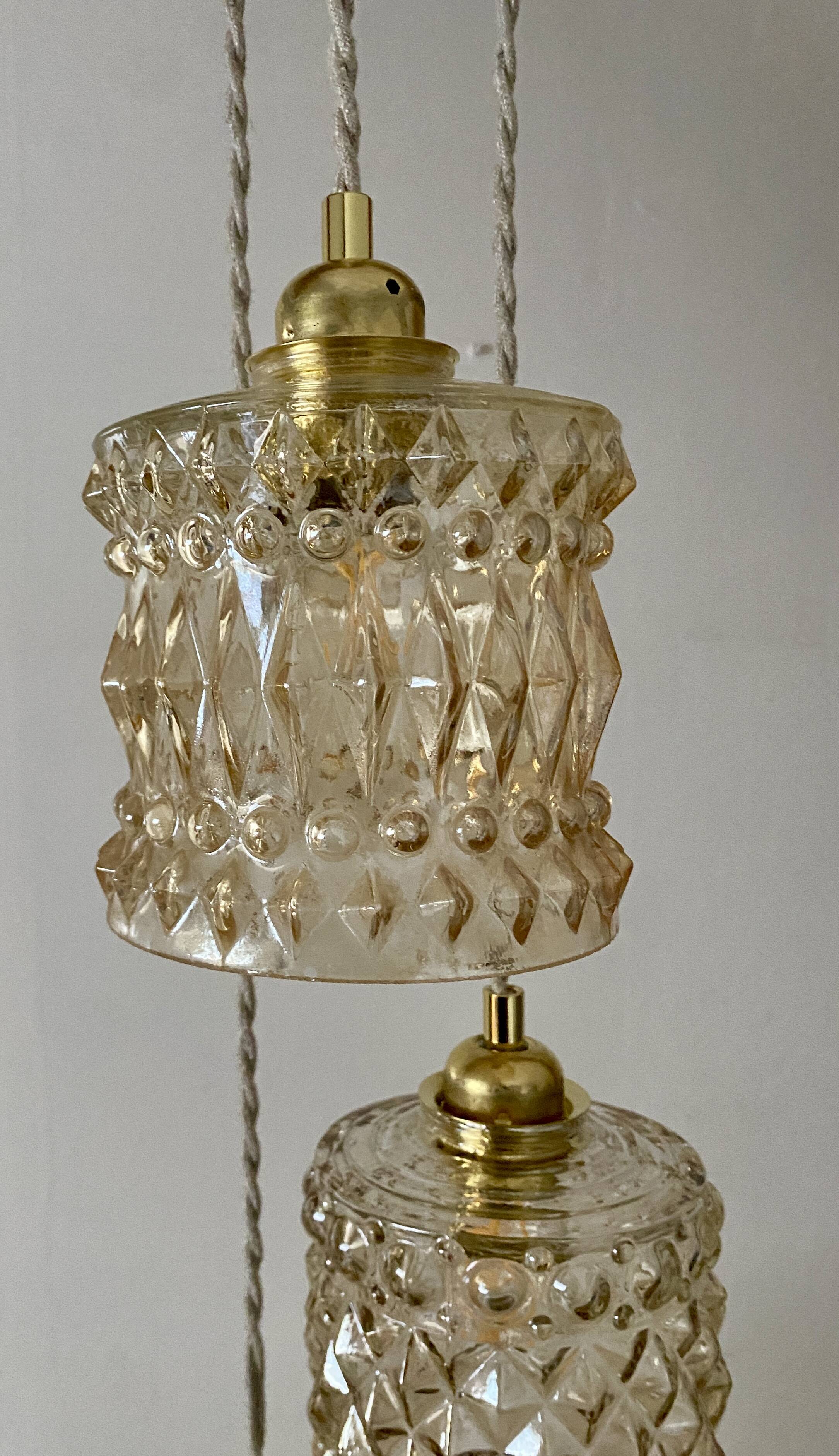 Triple antique globe pendant light in amber glass