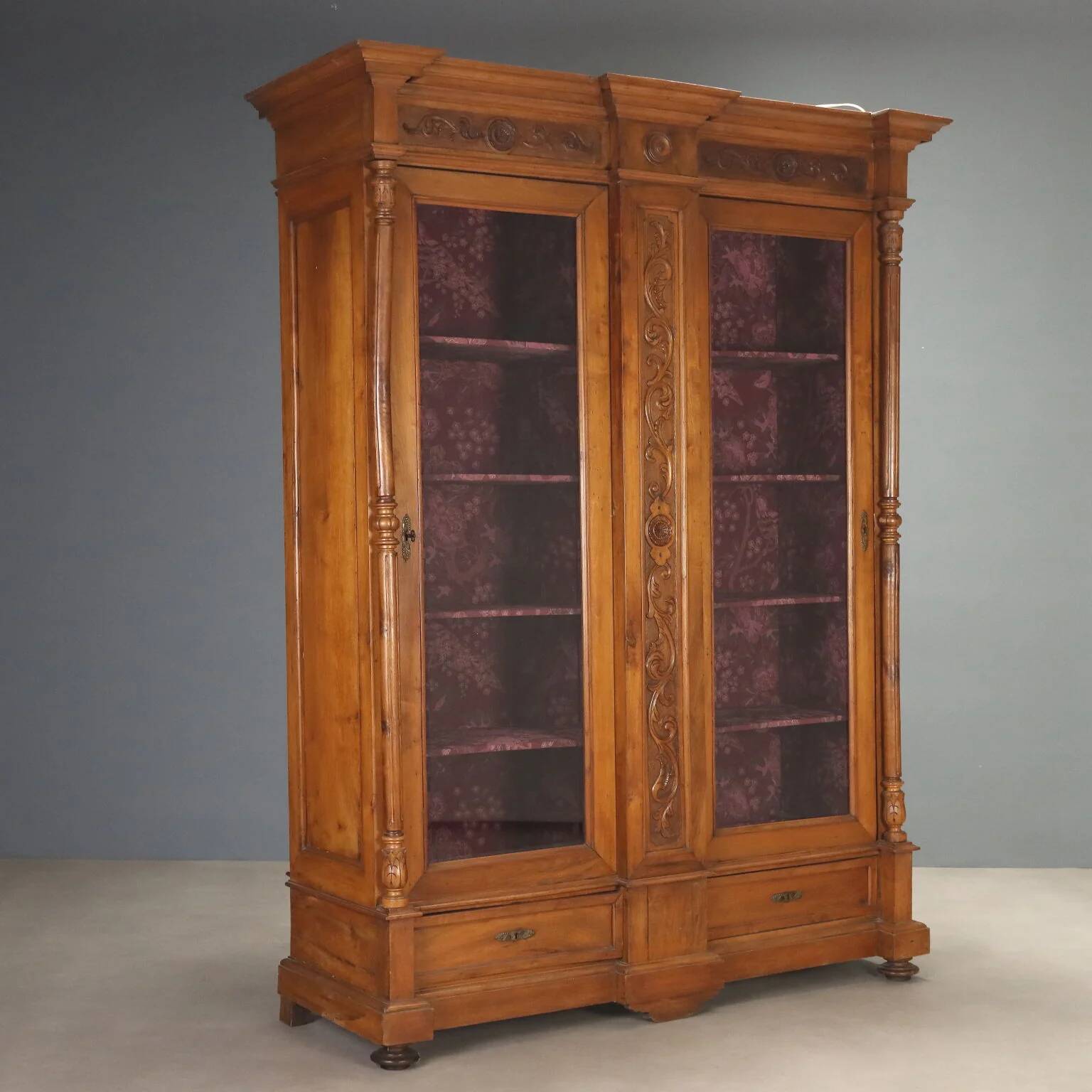 Antique walnut wardrobe with glass and carvings, Italy, 19th century.