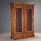 Antique walnut wardrobe with glass and carvings, Italy, 19th century.