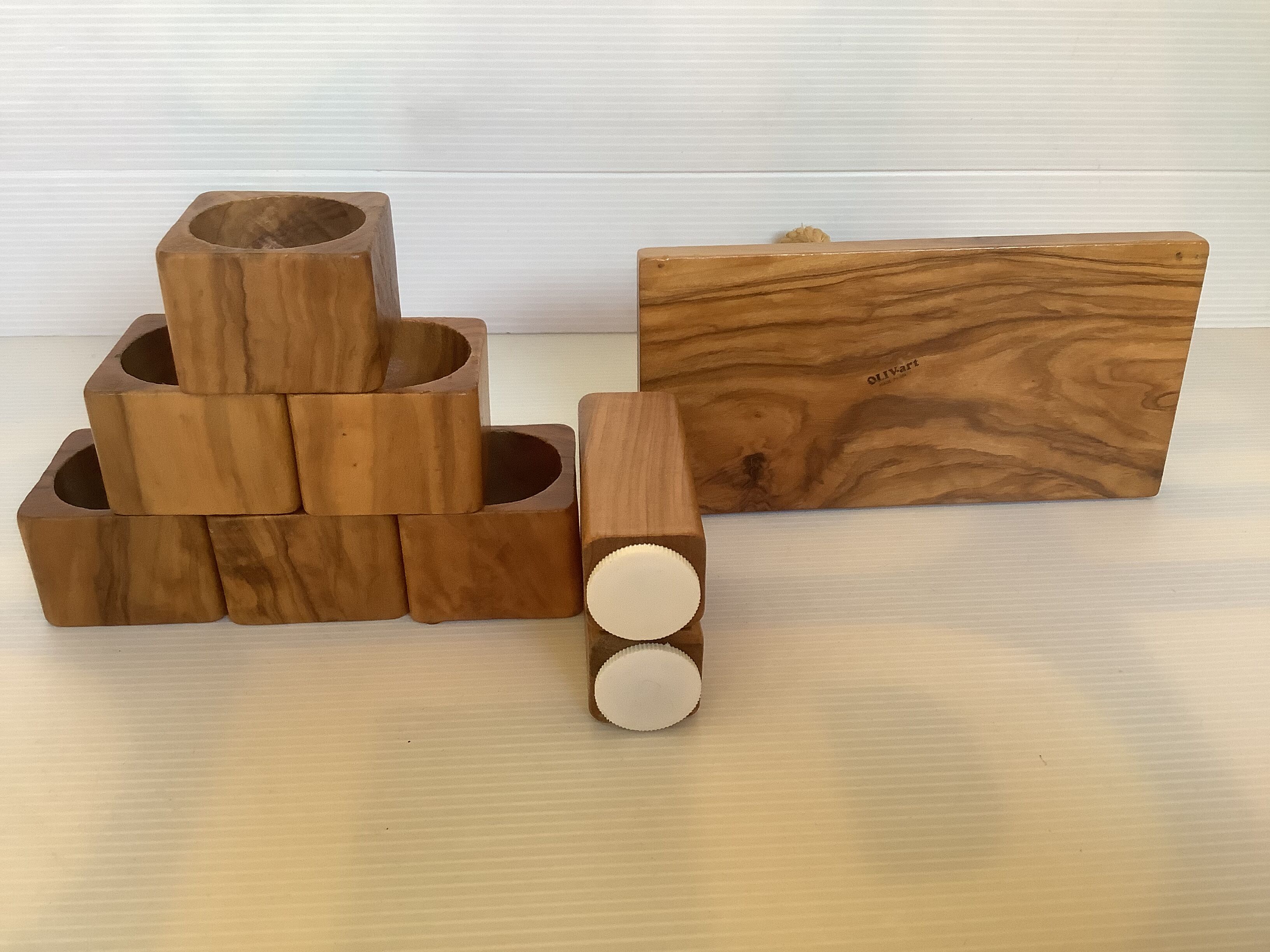 Six olive wood salt and pepper egg cups with their holder.