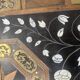 Blackened wood display table with marquetry top, Spain, 19th century.
