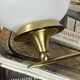 Pair of vintage wall sconces in brass with white glass globe shades.