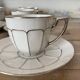 White and silver Limoges porcelain coffee cups and saucers.