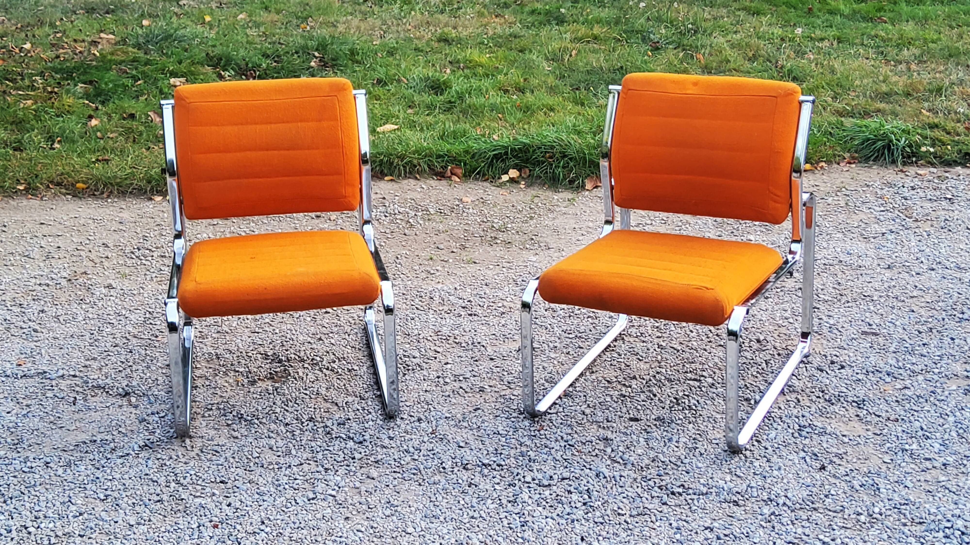 Pair of designer armchairs in orange fabrics and chrome tubes from the 70s