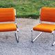 Pair of designer armchairs in orange fabrics and chrome tubes from the 70s