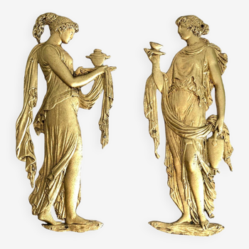 Pair of female bas-reliefs in gilded bronze