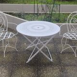 Folding round table and four wrought iron armchairs