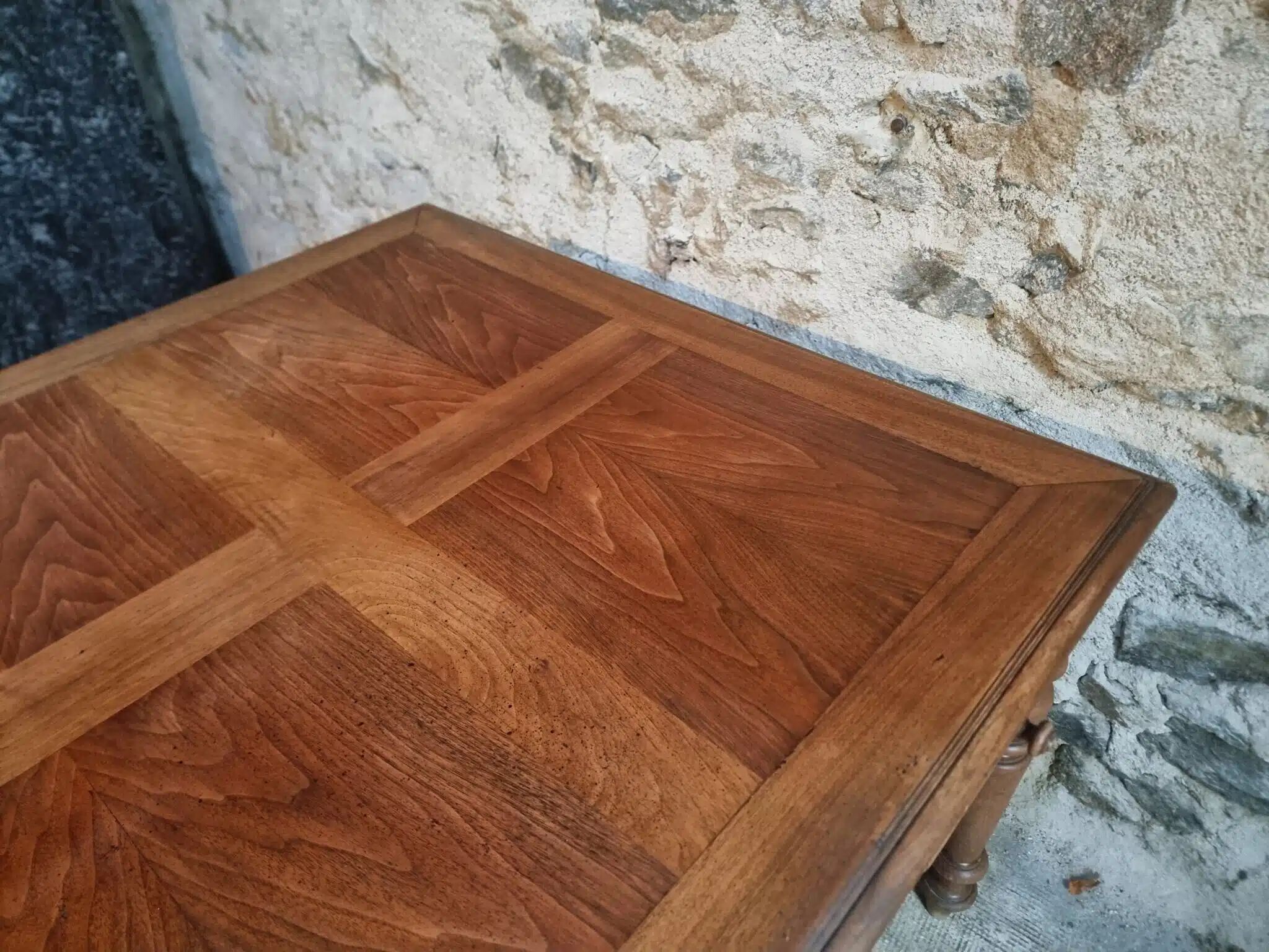 Antique French walnut table with six drawers, parquet top, early 20th century.