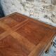 Antique French walnut table with six drawers, parquet top, early 20th century.
