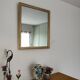Antique mirror with a gilded frame and beaded border.