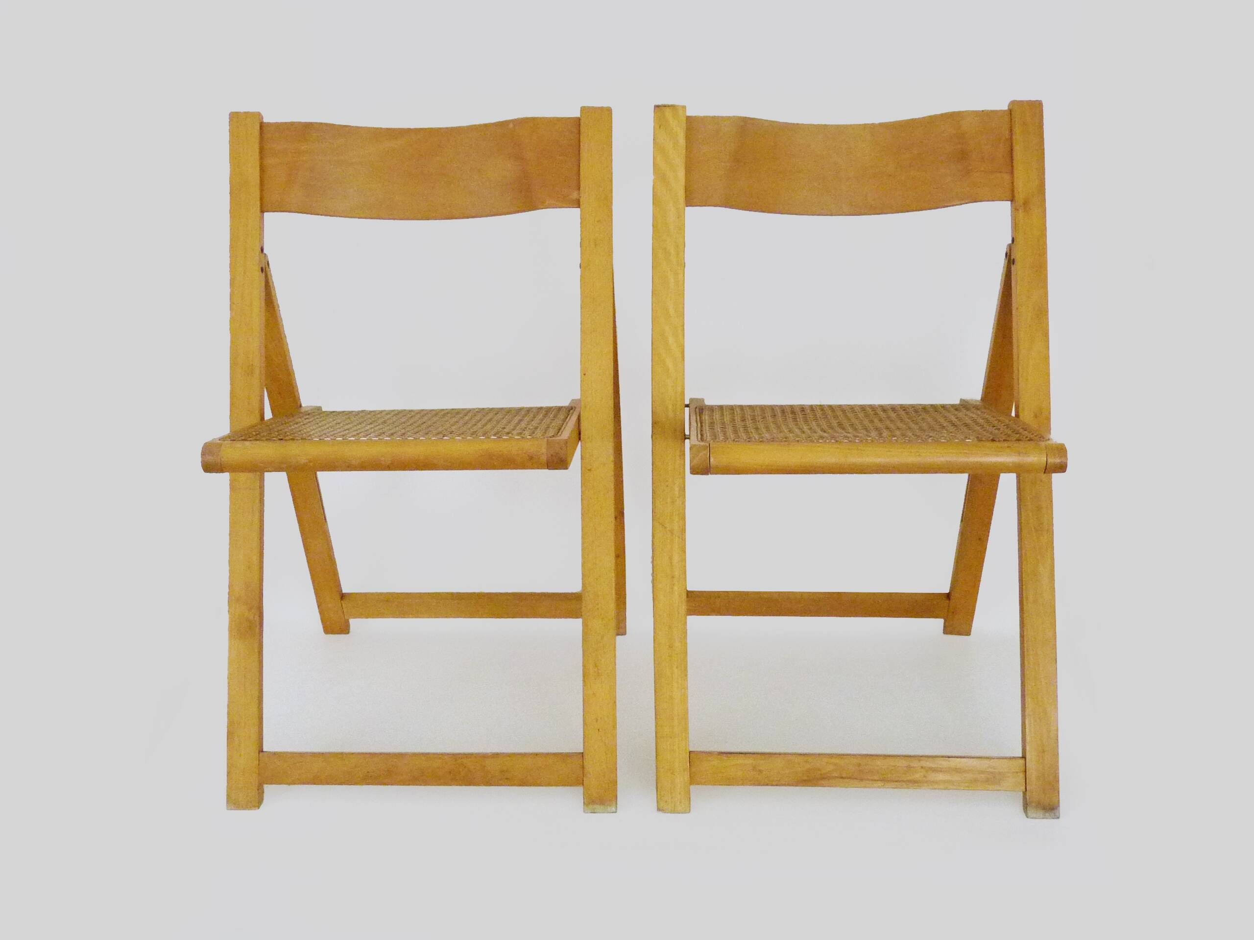 Pair of vintage folding chairs in beech and canework. Italy 70s