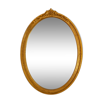 Antique oval-shaped gilded mirror