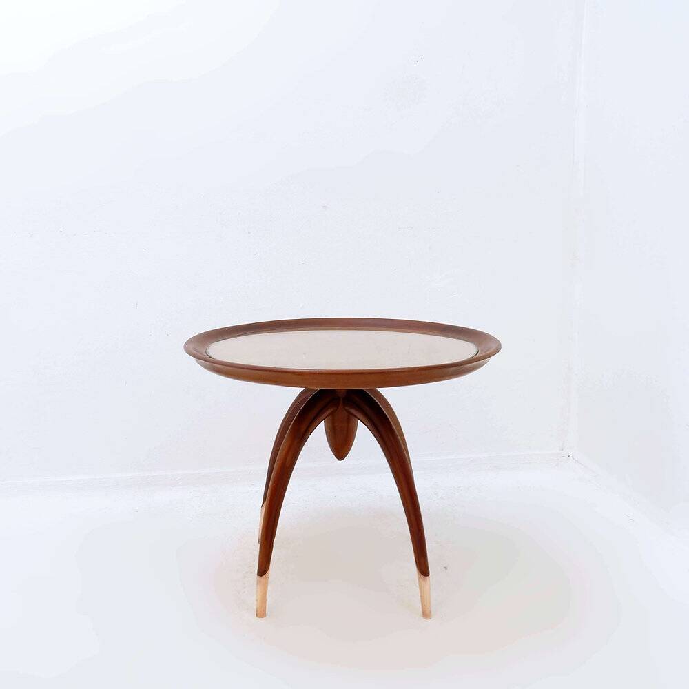Round Art Deco side table in wood with curved legs and brass feet.