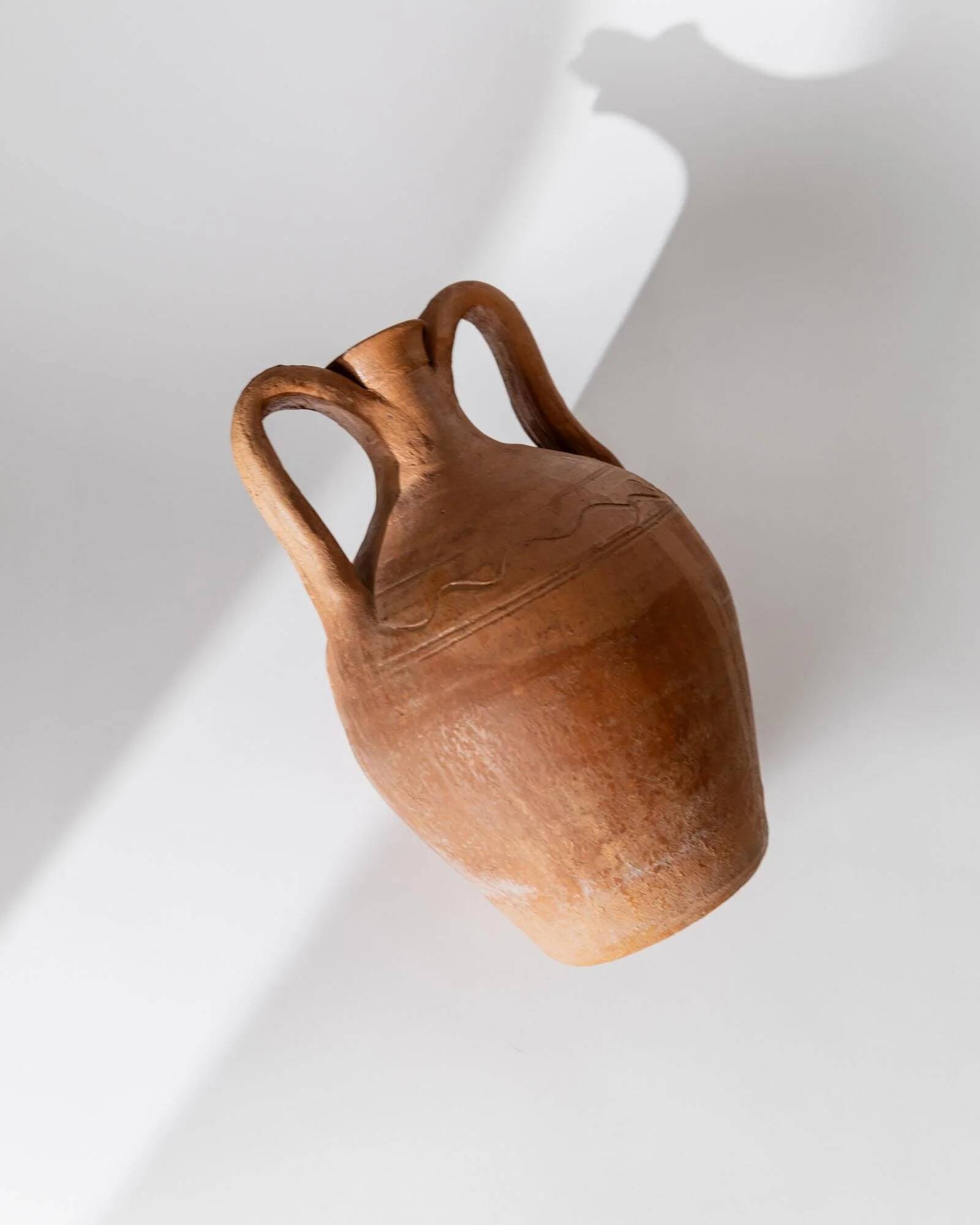 Vintage terracotta amphora vase from the early 19th century, handmade Italian jug with two handles.