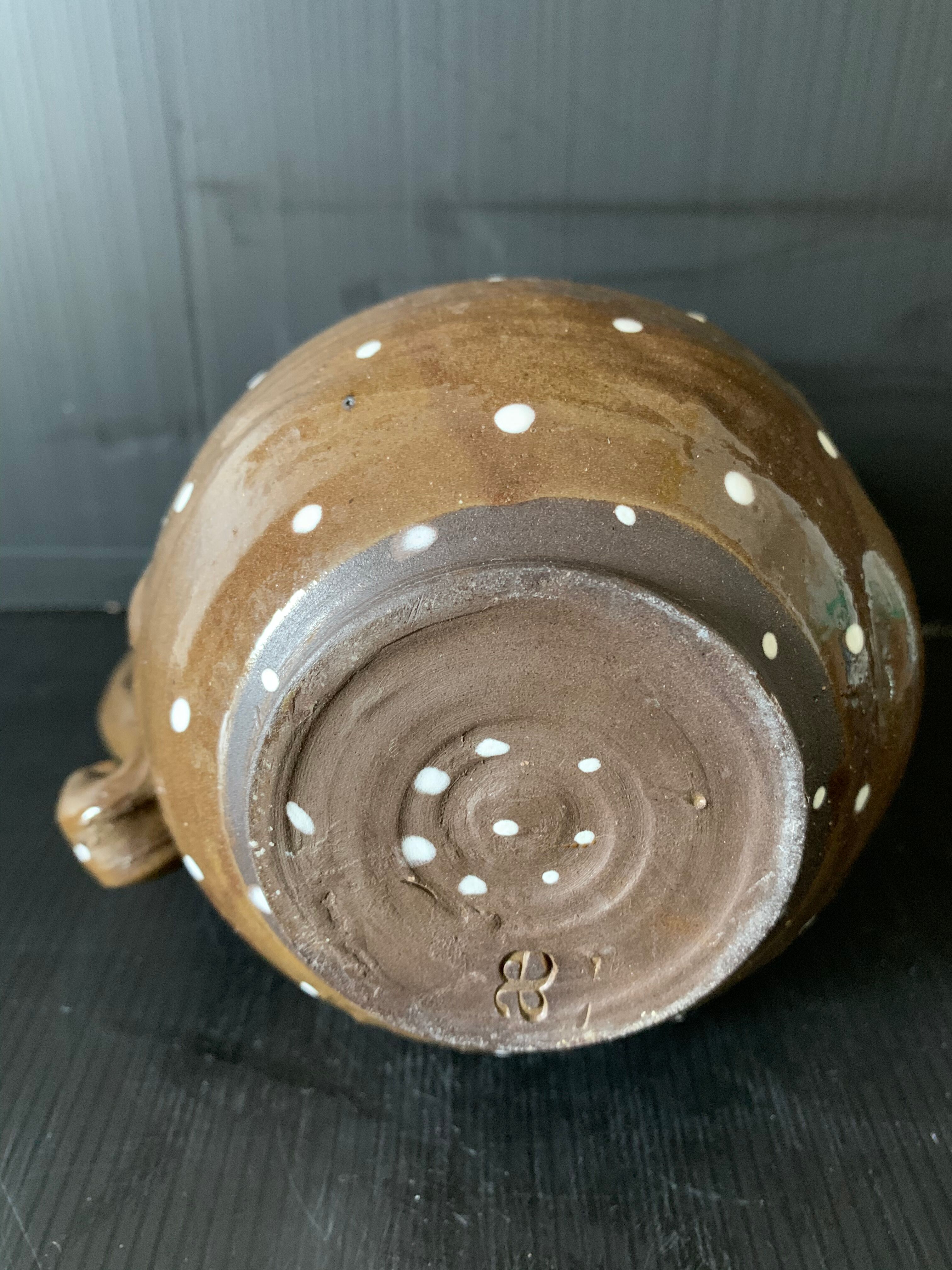 Brown enamelled ceramic pitcher with polka dots