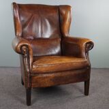 Dark wingback armchair made of sheep leather with stunning colors