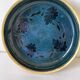Blue floral glazed stoneware plate with a yellow rim.
