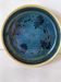 Blue floral glazed stoneware plate with a yellow rim.